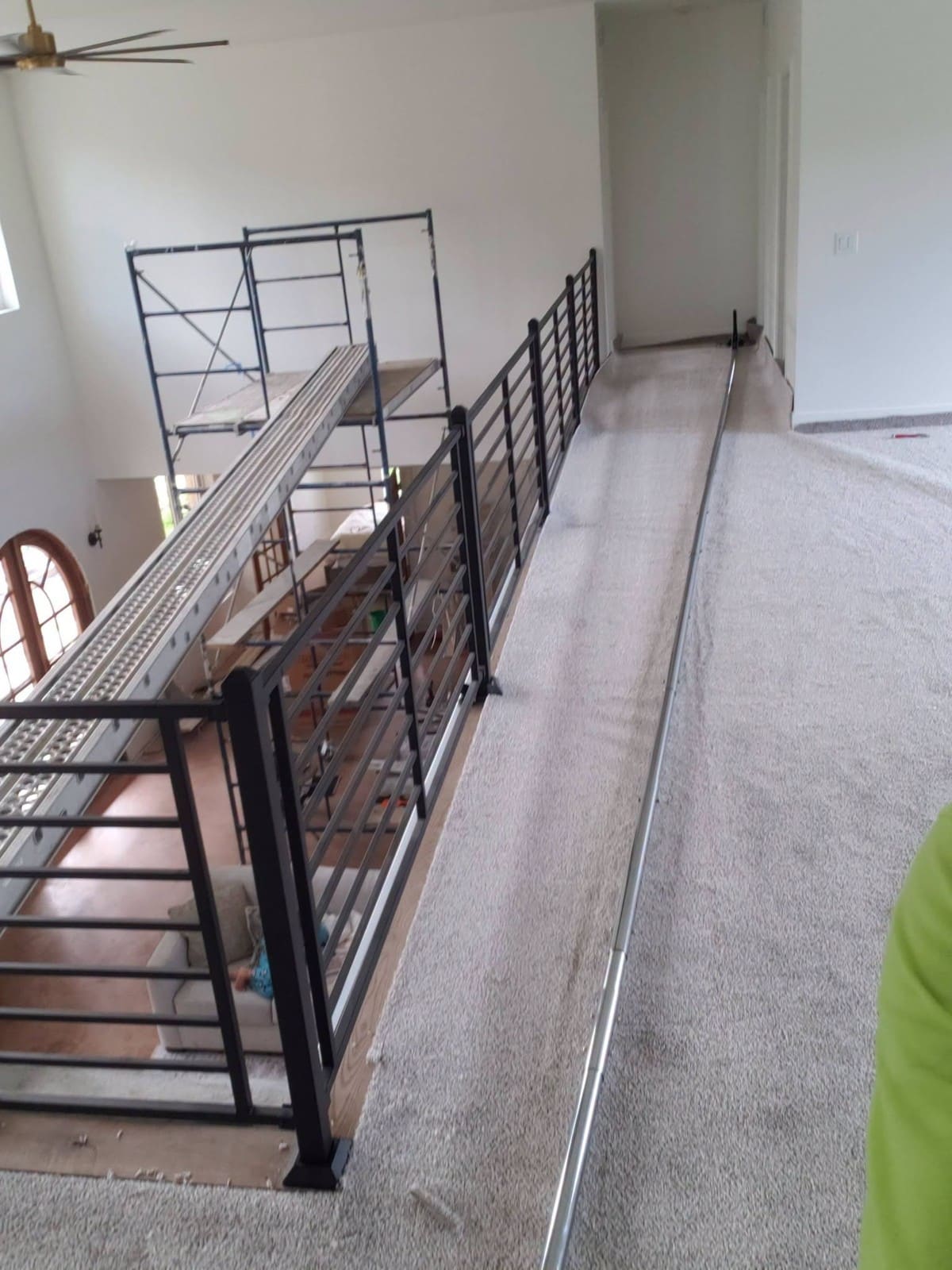 Metal mezzanine platform with railings under construction in empty warehouse space